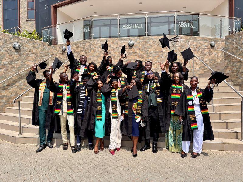 A group of graduating students celebrating outside the Health Access Institute in Accra